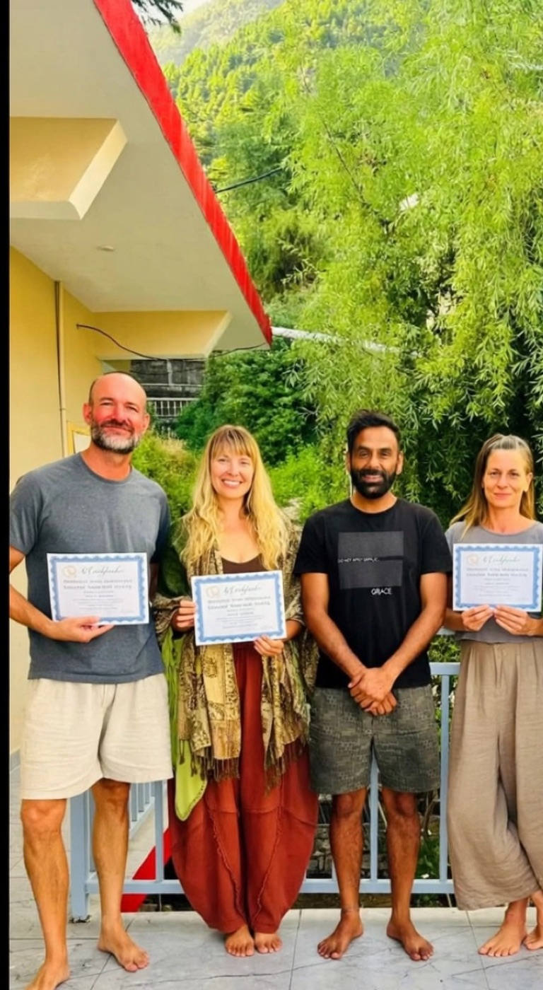 Graduates holding their certificates with Jai Dev